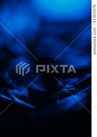 Blur neon glow. Bokeh light flare. Night moonlight. Defocused ultraviolet navy blue color glare flecks on dark black abstract background. 91403476