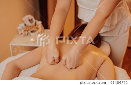 Top view of happy masseur massaging young woman back on a massage table, concept of massage spa treatments, healthy lifestyle 91404731