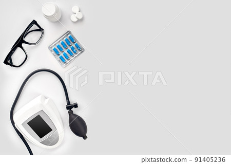 Electronic medical tonometer for measuring blood pressure on a white table Electronic medical tonometer for measuring blood pressure on a white table 91405236