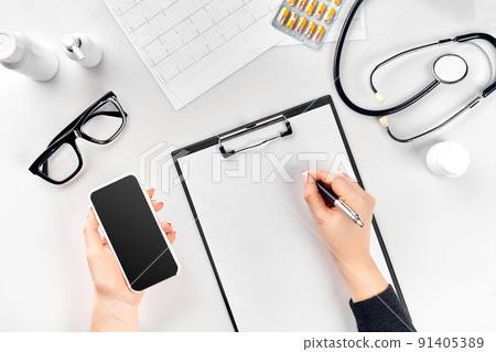 Doctor's work with stethoscope and copybook on hospital desk background. Top view Doctor's work with stethoscope and copybook on hospital desk background. Top view 91405389