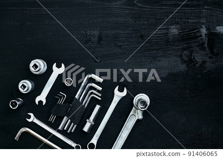 Flat lay of set of tools for car repairing such as wrenches on black wooden background. Top view. Flat lay of set of tools for car repairing such as wrenches on black wooden background. Top view. 91406065