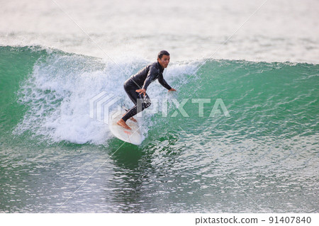 A man enjoying surfing in the sea of Shonan A man enjoying surfing in the sea of Shonan 91407840