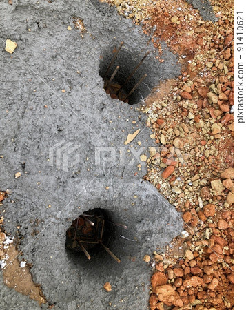 Hole ready for filling with ready-mixed concrete to make the foundation of the house under construction Hole ready for filling with ready-mixed concrete to make the foundation of the house under construction 91410621
