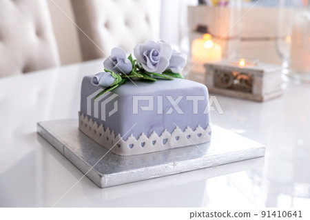 Beautiful decorated fruit cake with blue roses Beautiful decorated fruit cake with blue roses 91410641