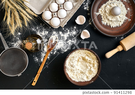 Pasta cooking ingredients on black kitchen table. Top view with space for your text Pasta cooking ingredients on black kitchen table. Top view with space for your text 91411298