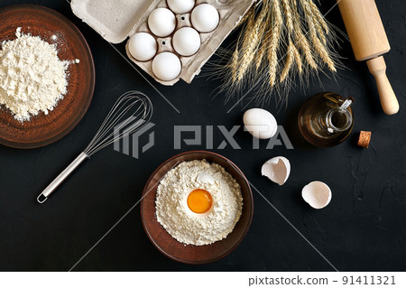 Pasta cooking ingredients on black kitchen table. Top view with space for your text Pasta cooking ingredients on black kitchen table. Top view with space for your text 91411321