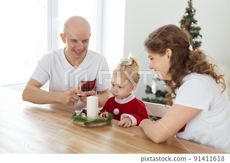 Baby child with hearing aid and cochlear implant having fun with parents in christmas room. Deaf , diversity and health concept Baby child with hearing aid and cochlear implant having fun with parents in christmas room. Deaf , diversity and health concept 91411618