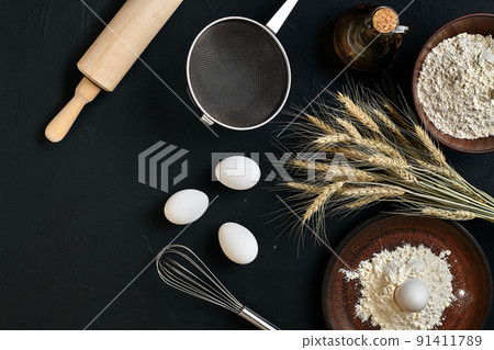 Preparation cooking baking kitchen table brown dishes ware fresh grocery different ingredients: eggs, flour, oil, stuff top view 91411789