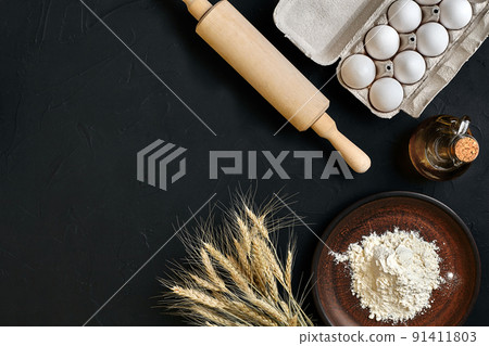 Preparation cooking baking kitchen table brown dishes ware fresh grocery different ingredients: eggs, flour, oil, stuff top view Preparation cooking baking kitchen table brown dishes ware fresh grocery different ingredients: eggs, flour, oil, stuff top view 91411803
