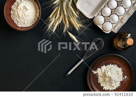 Preparation cooking baking kitchen table brown dishes ware fresh grocery different ingredients: eggs, flour, oil, stuff top view 91411810