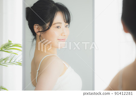 A woman looking at her A woman looking at her 91412281