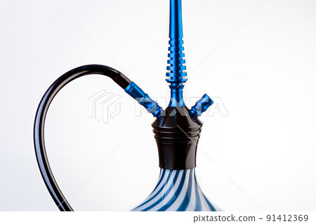 Part of a hookah isolated on a white background. Hookah with black rubber tube and white and blue flask isolated on white background. 91412369