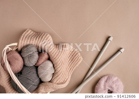 Different colored yarn in basket with knitting needles. Top view Different colored yarn in basket with knitting needles. Top view 91412606