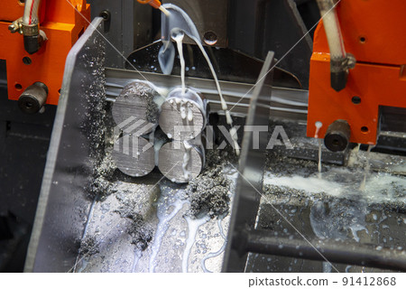 Close up scene the band saw machine cutting the metal rod. 91412868