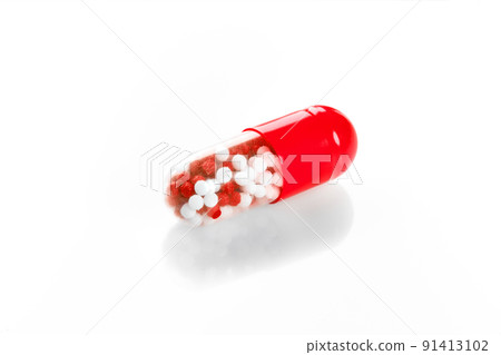 Macro red medical pill tablet with pellet, microgranules isolated on white 91413102