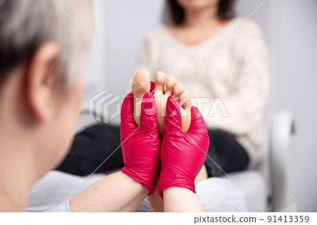 Foot treatment in SPA salon. Patient on medical pedicure procedure 91413359
