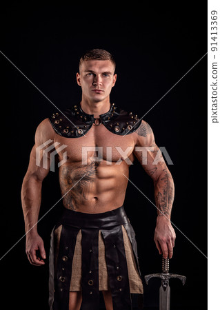 Antique warrior with sword against dark background 91413369
