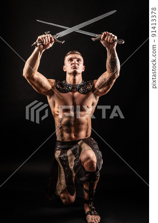 Antique warrior with sword against dark background Antique warrior with sword against dark background 91413378