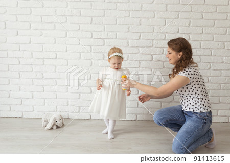 Banner baby child with hearing aids and cochlear implants plays with parents on floor, copy pace and place for advertising. Deaf and rehabilitation and diversity concept 91413615