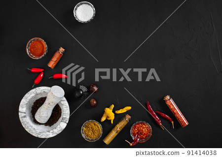 Various spices and mortar on black background with copy space Various spices and mortar on black background with copy space 91414038