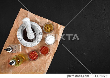 Various spices and mortar on black background with copy space Various spices and mortar on black background with copy space 91414075