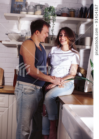 young caucasian couple together having fun on kitchen, woman pregnant, lifestyle people concept close up 91414167