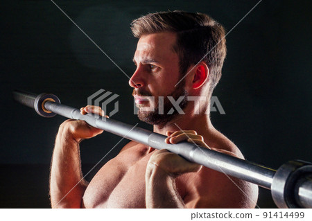 Muscular fitness man antique statue perfect muscles six pack abs and bare nude chest bodybuilder Apollo model bodybuilder makes exercise barbell for biceps in the gym on a black background Muscular fitness man antique statue perfect muscles six pack abs and bare nude chest bodybuilder Apollo model bodybuilder makes exercise barbell for biceps in the gym on a black background 91414499