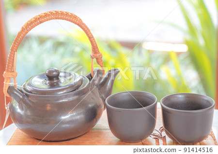 hand pour Chinese or Japanese traditional tea from clay pot hand pour Chinese or Japanese traditional tea from clay pot 91414516