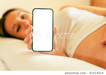 Pregnancy screen mockup. Mobile pregnancy online maternity application mock up. Pregnant mother using phone. Concept of pregnancy, maternity, expectation for baby birth. 91414814