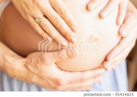 Pregnant belly hands. Happy pregnancy woman and husband hugging pregnant belly. Concept maternity, pregnancy, childbirth. Pregnant belly hands. Happy pregnancy woman and husband hugging pregnant belly. Concept maternity, pregnancy, childbirth. 91414825