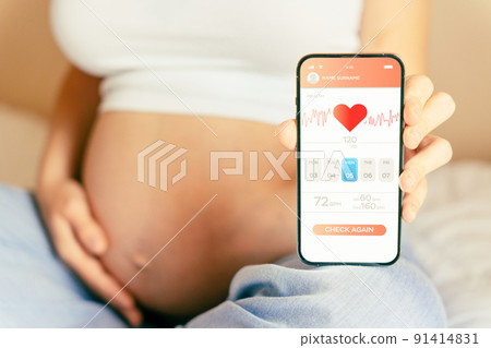 Pregnancy health app. Pregnant woman holding smartphone. Mobile pregnancy online maternity application. Concept of pregnancy, maternity, expectation for baby birth. Pregnancy health app. Pregnant woman holding smartphone. Mobile pregnancy online maternity application. Concept of pregnancy, maternity, expectation for baby birth. 91414831