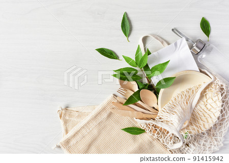 Eco friendly disposable dishes made of bamboo wood and paper on white wooden background. 91415942