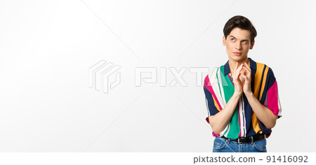 Devious young man having a plan, steeple fingers and looking cunning at upper left corner, scheming something, standing over white background Devious young man having a plan, steeple fingers and looking cunning at upper left corner, scheming something, standing over white background 91416092