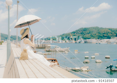 A woman in a one-piece swimsuit and summer sky A woman in a one-piece swimsuit and summer sky 91418507