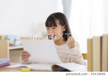 Girl elementary school student who is pleased with the result of the test Girl elementary school student who is pleased with the result of the test 91419606