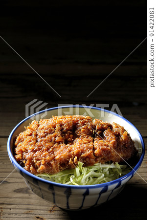 Sauce and bowl with cutlet entwined with plenty of sauce on top of shredded cabbage Sauce and bowl with cutlet entwined with plenty of sauce on top of shredded cabbage 91422081