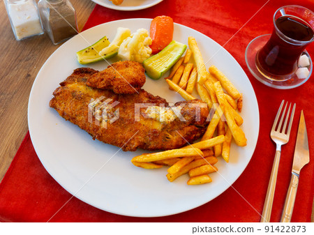 Turkish grilled breaded mackerel fillet with fried potatoes 91422873