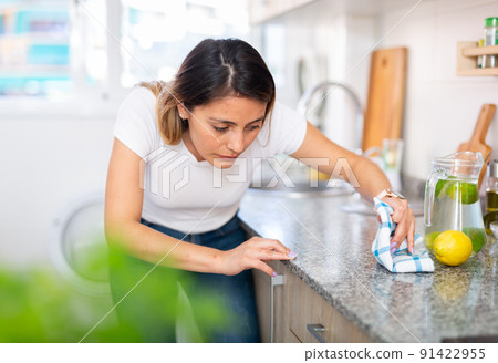 Female is caring about clean of kitchen 91422955