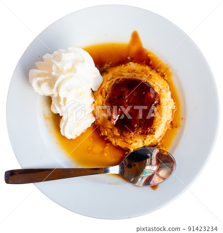 Delicate vanilla caramel flan served with whipped cream 91423234
