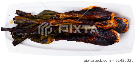 Calcot served on table with romesco sauce and botifarra 91423323