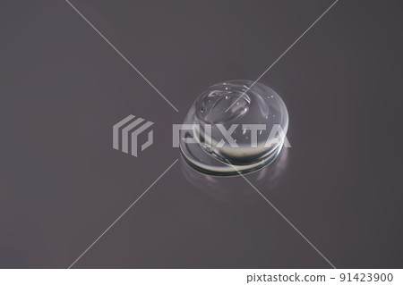 Drop of cosmetic transparent gel on a grey background. The texture of the serum, heir gel or hyaluronic booster. Drop of cosmetic transparent gel on a grey background. The texture of the serum, heir gel or hyaluronic booster. 91423900