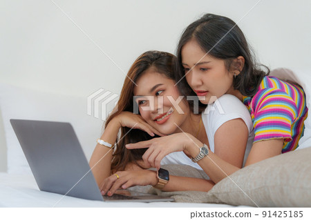 Young Asian Women LGBT lesbian couple love moments happiness at bedroom. LGBTQ or Gay and pride concpet. Young Asian Women LGBT lesbian couple love moments happiness at bedroom. LGBTQ or Gay and pride concpet. 91425185