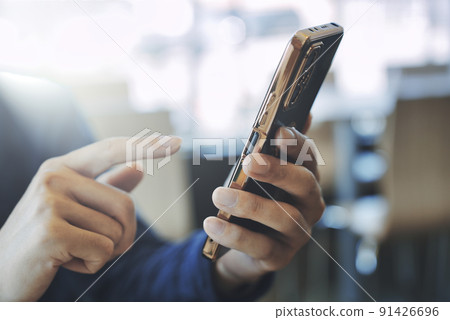 Hands of a man with a smartphone Hands of a man with a smartphone 91426696