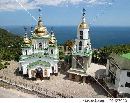 Christian church in the mountains above the sea. Temple of the Holy Archangel Michael in Oreanda. The southern coast of Crimea. Aerial view Christian church in the mountains above the sea. Temple of the Holy Archangel Michael in Oreanda. The southern coast of Crimea. Aerial view 91427020