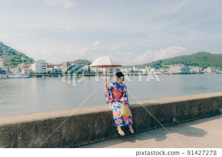 A woman in a yukata and a tourist spot in the summer sky A woman in a yukata and a tourist spot in the summer sky 91427278