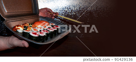 Set of delicious sushi rolls with wassabi and ginger in a box. Japanese food. 91429136