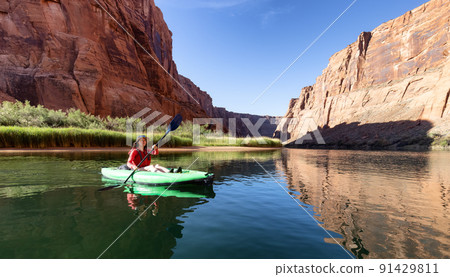 Adventurous Woman on a Kayak paddling in Colorado River. 91429811