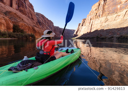 Adventurous Woman on a Kayak paddling in Colorado River. 91429813