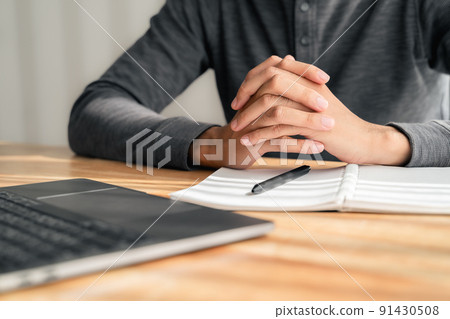 Close up of man clasped hands clenched together on table, businessman preparing for job interview, concentrating before important negotiations, thinking or making decision, business concept 91430508