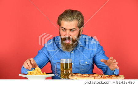bearded man with beer and pizza. italian food. French bearded man with beer and pizza. italian food. French 91432486